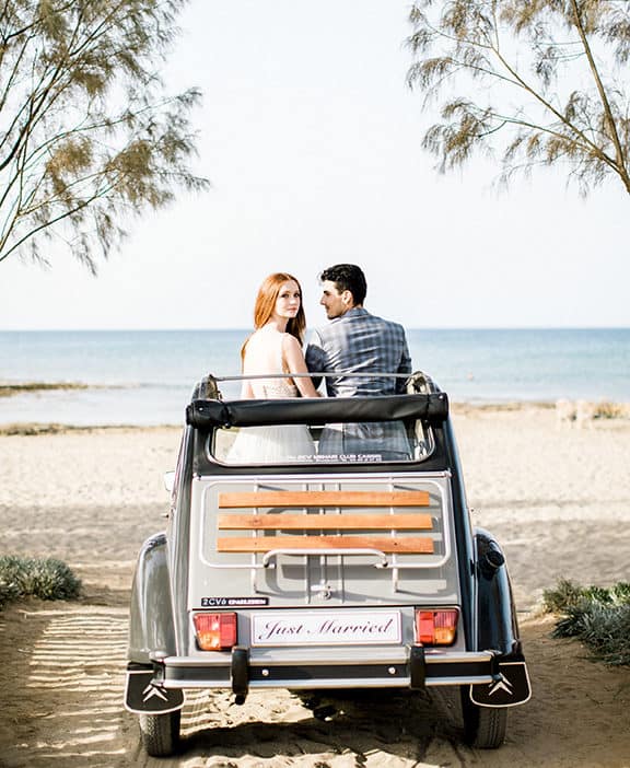 wedding photography bride and groom with a classic car