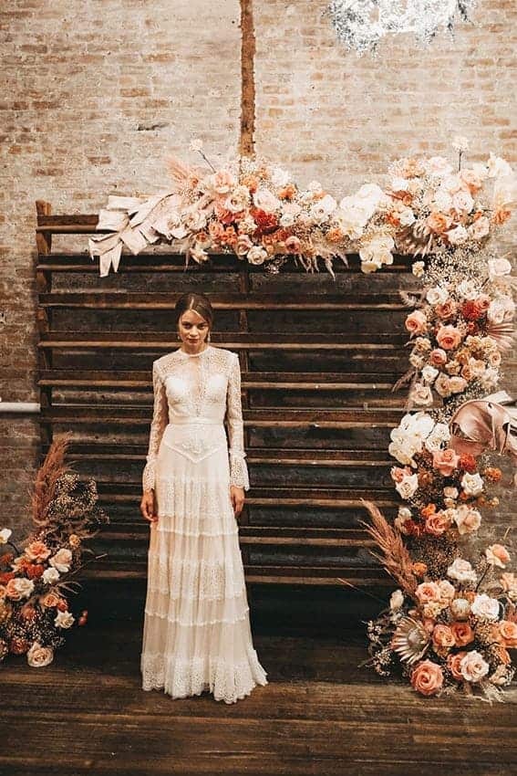 wedding backdrop with flowers in dusty orange colours