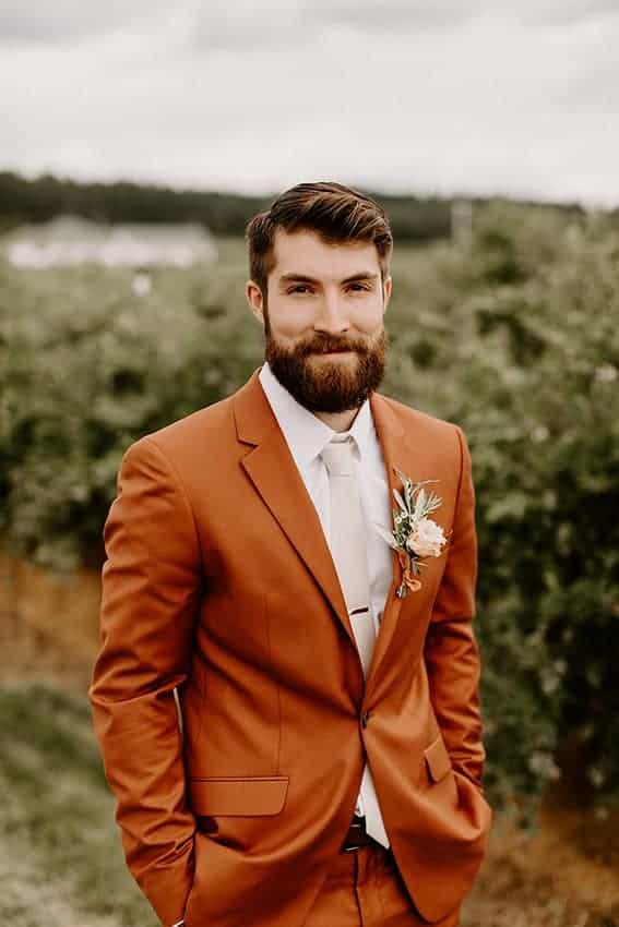 groom with dusty orange suit