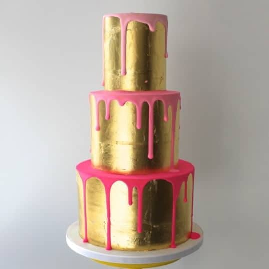 golden wedding cake with pink details