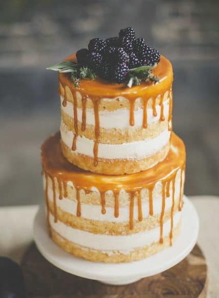 naked wedding cake with caramel and blackberries