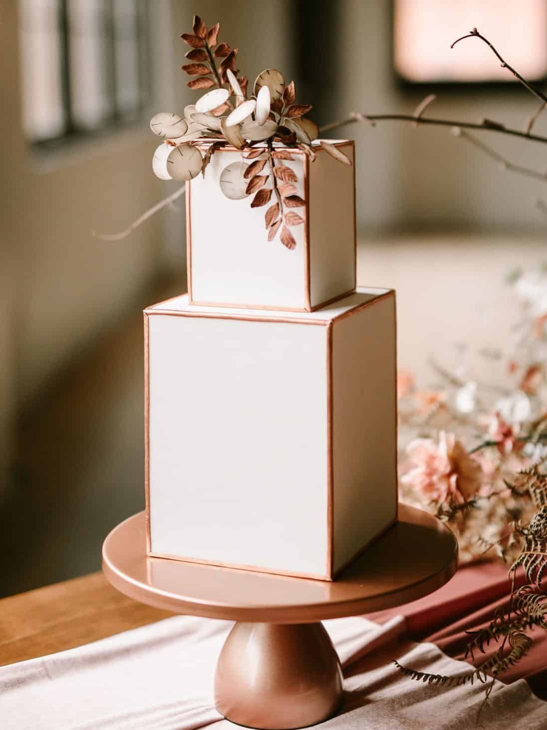 geometric wedding cake with dried leaves