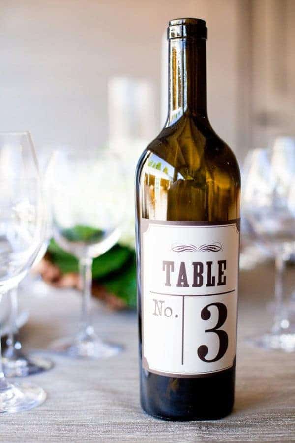 wedding dinner table numbering with a wine bottle