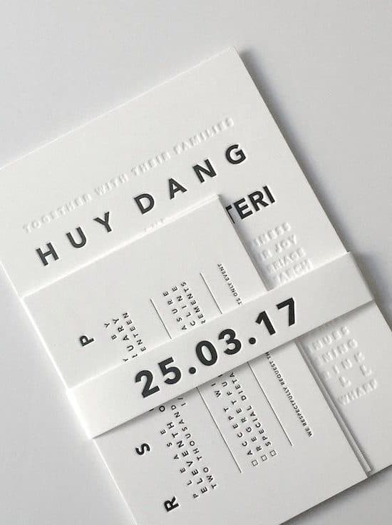 simple black and white wedding invitation with embossed typography