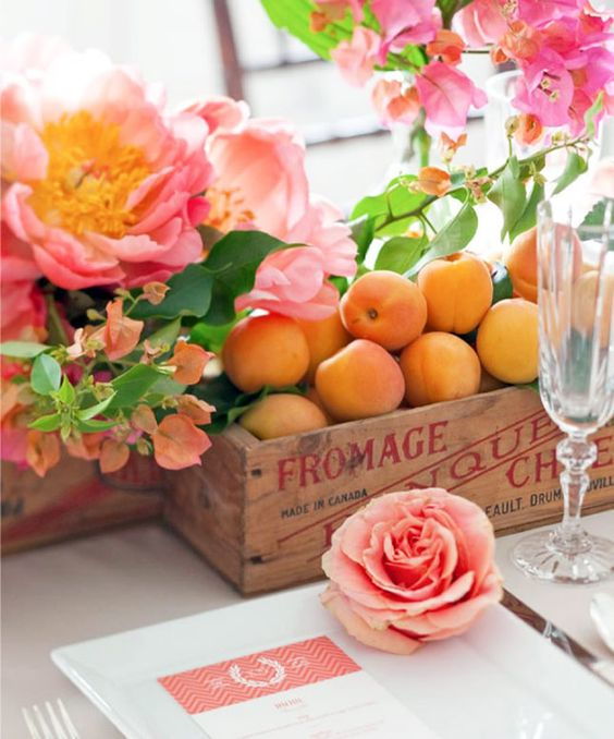 wedding decoration centrepiece with a wooden box of peaches and pink roses